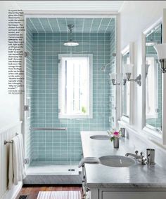 a bathroom with blue tile and wooden floors