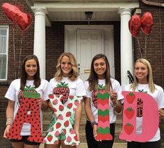 four girls are holding up letters that spell out i love you and strawberry shortcakes