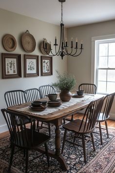 a dining room table with chairs and plates on it