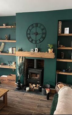 a living room filled with furniture and a clock mounted to the side of a wall