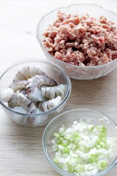 three bowls filled with meat and vegetables on top of a wooden table next to each other