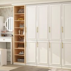 a bedroom with white closets and wooden flooring next to a large mirror on the wall