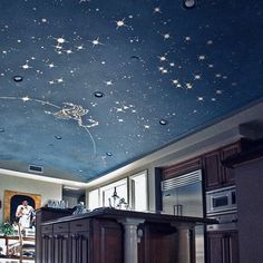 the ceiling is painted with stars and other things on it, as well as a kitchen island