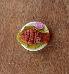 a small plate with some food on it sitting on top of a wooden table next to a fork and knife