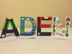 the letters are made out of paper and have mario characters on them