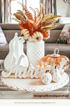 a table topped with white pumpkins and fall decorations on top of a coffee table