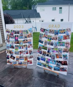 two canvass with pictures on them sitting in the middle of a yard next to a house