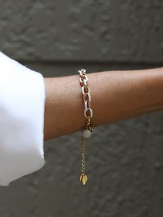 The white enamel on the gold chain bracelet adds a sleek and elegant touch, while the stainless steel base provides durability. Chain is made of stainless steel, gold ION plated with 18k gold. This bracelet effortlessly elevates any ensemble, making a bold yet refined statement. Elegant and stylish, it's a versatile accessory that complements both formal and trendy attire, adding a touch of luxury to any look. Length of the chain is 16 inches including the clasp. There is 2'' extender chain for White Minimalist Metal Jewelry, Modern White Jewelry With Delicate Chain, Minimalist White Metal Jewelry, White Jewelry With Adjustable Chain For Everyday, Modern White Stainless Steel Bracelets, Minimalist White Jewelry With Adjustable Chain, Trendy White Stainless Steel Bracelets, Modern White Chain Jewelry, Dainty White Chain Bracelet