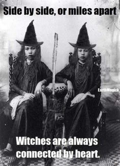 two women dressed in witches sitting next to each other