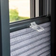 an open window with blinds on it and a handle in the middle of the window