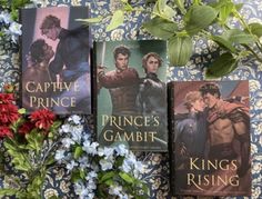 three books sitting on top of a table next to flowers and leaves, with the title prince's gambat written in english