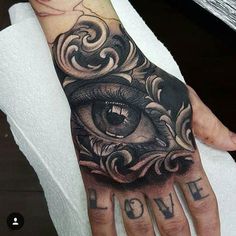 a person's hand with an eye on it and the word love written below