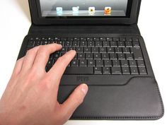 a person typing on an open laptop computer