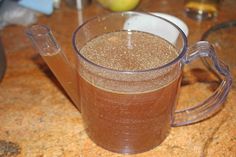 a pitcher filled with liquid sitting on top of a table