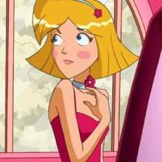 a woman in a pink dress standing next to a window with her hand on her hip