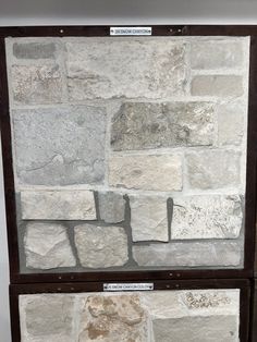 two display cases made out of stone with labels on the front and back sides, each containing different types of stones