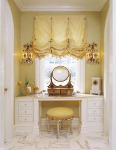 a room with a vanity, mirror and stool in it's center window sill