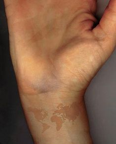 a person's arm with a small tattoo on it