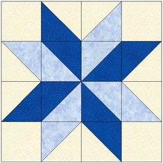 a blue and white quilt block with an arrow on it