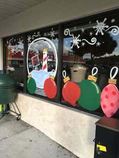 christmas decorations are displayed in the window of a store