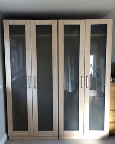 an empty room with some glass doors on the front and back of the closets