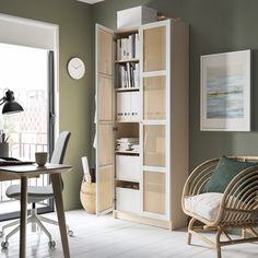 a living room filled with furniture and a book shelf next to a door leading to a patio