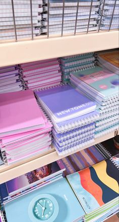 a book shelf filled with lots of books and binders on top of each other