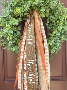 an orange and white ribbon hanging from a door