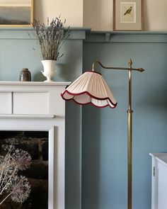 a living room with blue walls and a white fireplace