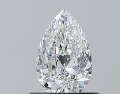 a pear shaped diamond sitting on top of a black stand in front of a gray background