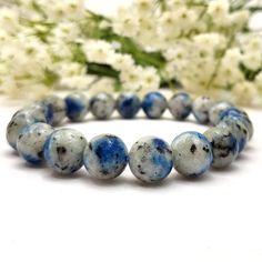 ✦Gemstone: Jasper ✦Color: Blue  ✦Shape: Round Bead ✦Wrist Size: 5''-9'' ✦Bead Size: 10mm ✦QTY: 1 pc / package ✦✦Please measure your wrist size, then order the bracelet. Elevate your style and tap into the healing energies of the universe with this stunning Blue K2 Jasper beaded bracelet. Handcrafted with care and attention to detail, this bracelet is not only a fashion statement but also a source of spiritual and emotional well-being. Healing Properties: Blue K2 Jasper is known for its harmonizing properties, connecting you to higher spiritual awareness. It is believed to promote balance and healing within the body and mind, making it a perfect companion for your meditation and chakra alignment practices. Gift Idea: This bracelet makes a meaningful and thoughtful gift for a loved one or yo Jasper Color, Jasper Bead Bracelet, Chakra Alignment, Art Deco Bracelet, Coral Beads, Jasper Beads, Bracelets Handmade Beaded, Chakra Healing, Gemstone Bracelets