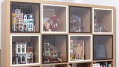 a display case filled with lots of toy figurines and legos on top of wooden shelves