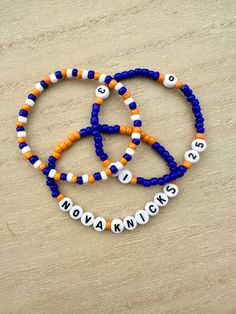 Support your Villanova Knicks with these vibrant blue and orange New York Knicks bracelets celebrating the four Villanova players Jalen Brunson, Mikal Bridges, Josh Hart, and Donte DiVincenzo.  This set of 3 bracelets are for Villanova and NY Knicks basketball fans. The blue and orange beaded friendship bracelets are designed to be stackable, allowing you to wear them together for a bold and impactful look. Alternatively, you can wear them individually or mix and match with other bracelets to cr Sporty Blue Bracelets For Sports Events, Personalized Blue Bracelets For Sports Events, Blue Sporty Bracelet For Sports, Mikal Bridges, Josh Hart, Beaded Friendship Bracelets, Donte Divincenzo, Jalen Brunson, Knicks Basketball