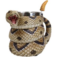 a snake wrapped around a cup with a toothpick in it's mouth