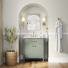 a bathroom with a sink, mirror and towel rack on the wall next to it