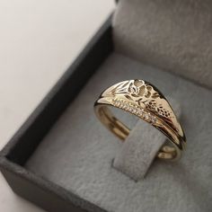 an open box with a gold ring in it