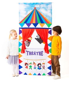 two children standing in front of a theatre sign