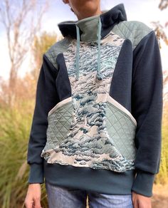 a woman wearing a quilted hoodie with clouds on it