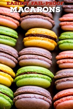 colorful macaroons are lined up in rows on a tray with the words, easter half - proof macaroons