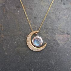 "This unique crescent moon phase pendant is available in silver or 14 k gold. So beautiful polished but equally stunning hand-finished matte, hammered or have it encrusted with diamonds. A focal piece that can be stacked with smaller pendants. It's a slide providing space for a pendant to fit into the opening. We've paired it with our bezel set moonstone. crescent moon 24 millimeters long x 19 mm wide or/ almost 1\" long x 3/4\" wide 14k solid gold or sterling silver pave Diamond encrusted Cresc Elegant Crescent Moonstone Jewelry, White Gold Moon-shaped Moonstone Jewelry, Fine Jewelry White Gold With Moon Phase, Fine Jewelry In White Gold With Moon Phase, Fine Jewelry In White Gold With Moon Phase Detail, Celestial Half Moon Jewelry For Anniversary, Celestial Crescent Jewelry In White Gold, Celestial Moon Phase White Gold Necklace, Celestial White Gold Moon Phase Necklace