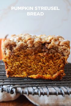 a loaf of pumpkin streusel bread sitting on top of a cooling rack