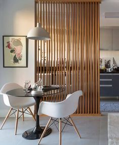 a dining room table and chairs in front of a wall with circles painted on it