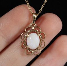 ~Chain length: 17&1/2 inch ~Pendant size: 7/8 x 1/2 inch ~Opal size: 8.25 x 6.5 mm ~Weight: 2.1 g ~Pendant have a hallmark of 14k and the chain is 925 silver Formal Opal Jewelry With Oval Cabochon, Formal Oval Cabochon Opal Jewelry, Oval Opal Necklace For Formal Occasions, White Oval Cabochon Jewelry For Formal Occasions, Classic Opal Jewelry For Formal Occasions, White Cabochon Jewelry For Formal Occasions, Antique White Oval Cabochon Jewelry, Maximalist Jewelry, Pretty Accessories