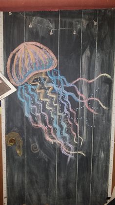 a chalk drawing of a jellyfish on a blackboard