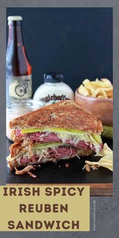 a sandwich cut in half sitting on top of a table next to a bottle of beer