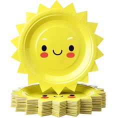 a stack of yellow plates with a smiling sun design on the front and center, sitting next to each other