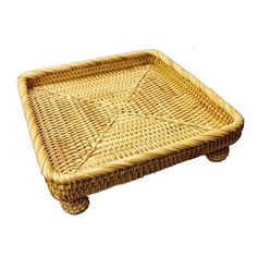 a square wicker tray with four legs