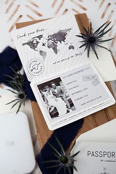 a passport and some plants on top of a wooden cutting board with other items around it