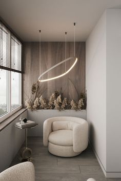 a living room filled with furniture and a round light fixture hanging from the ceiling above it