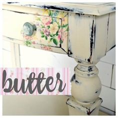 an old table with flowers painted on it and the word butter written in black ink